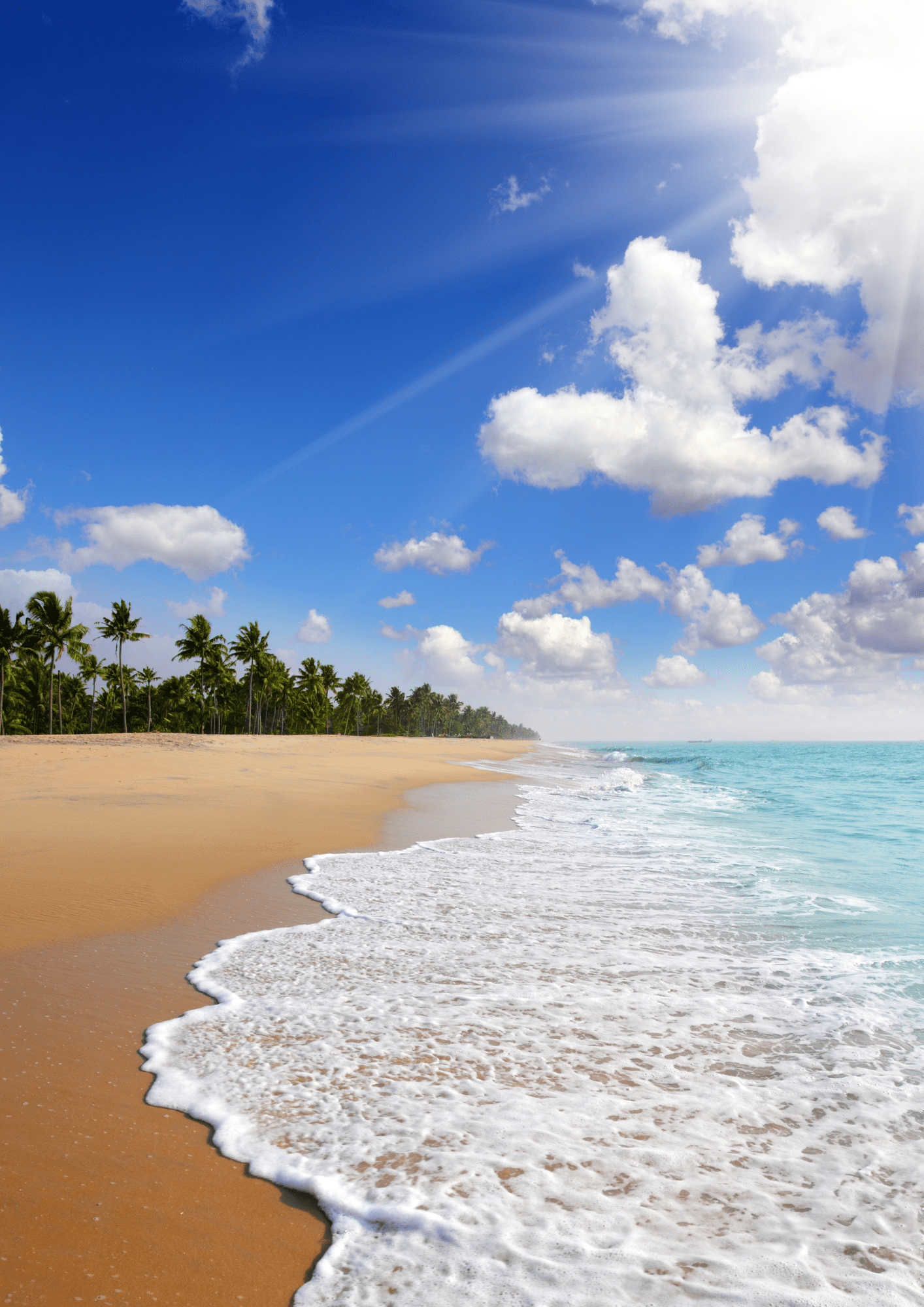A beach showcasing waves rolling onto it.
